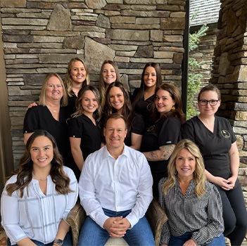 Smiling orthodontic team member in Rochester at computer