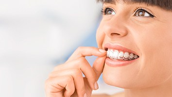 Woman taking out her clear aligners