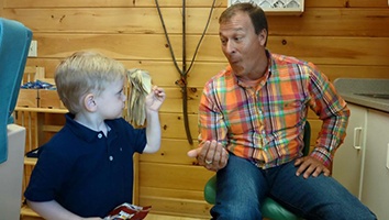 Dr. Drabik and young child in orthodontic office