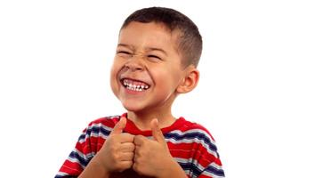 Portrait of happy young boy against white background