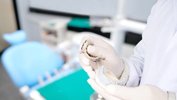 Orthodontist in Rochester holding mold of retainer