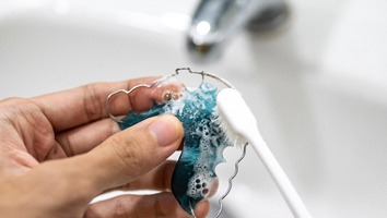 Patient cleaning their retainer in Webster