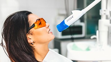 Woman relaxing during in-office whitening treatment