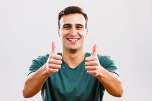 Man smiling with braces