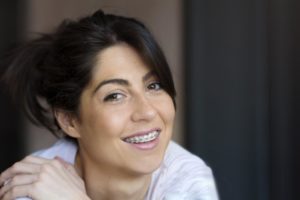 Woman smiling with braces while looking at camera