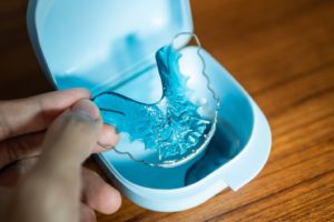 Picture of a retainer being removed from its case.