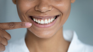 Woman pointing to her perfectly straight smile