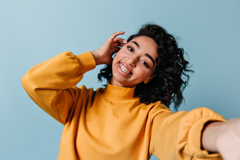 Woman smiling with orthodontic treatment